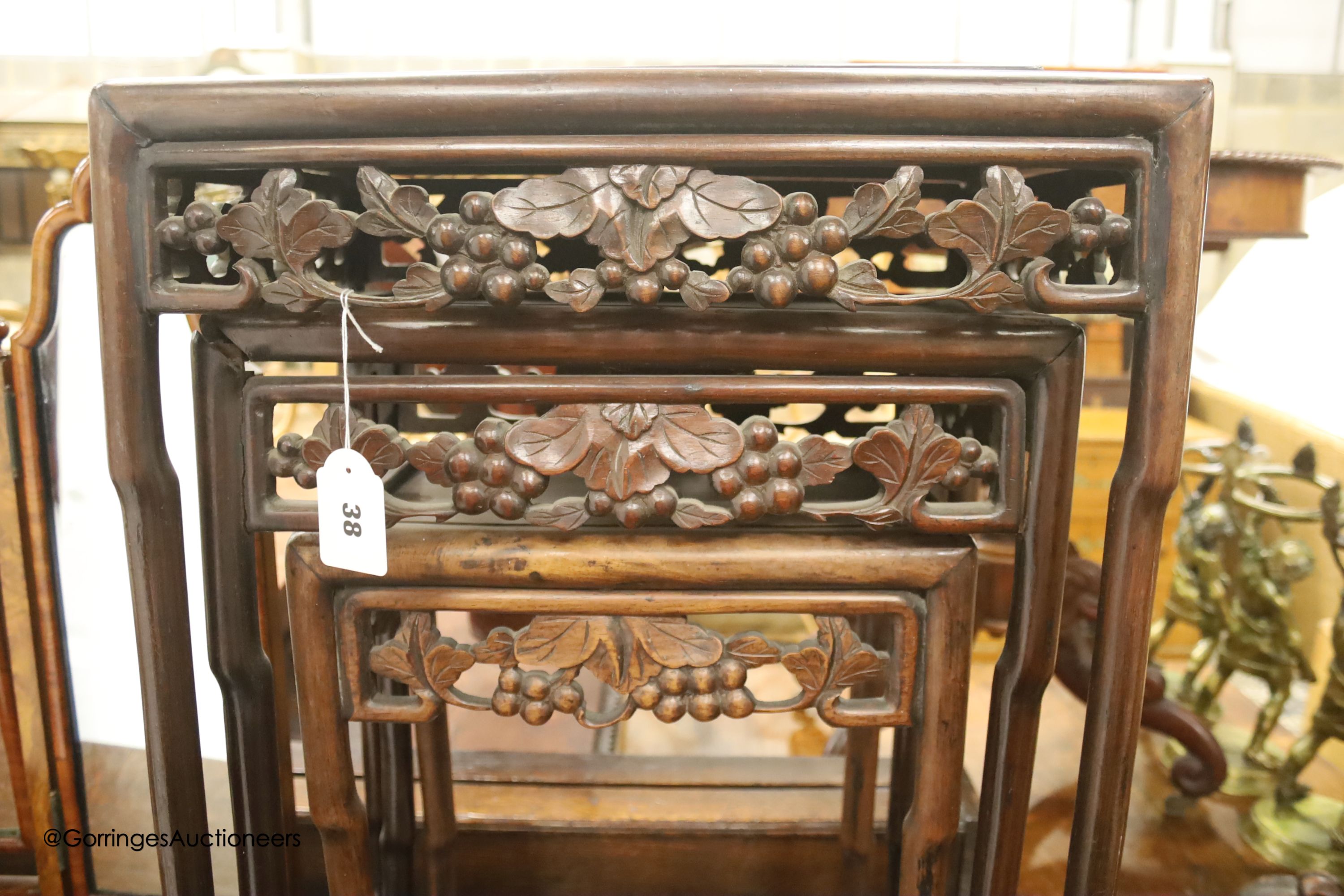 A nest of three Chinese rectangular carved hardwood tables, width 45cm, depth 33cm, height 54cm